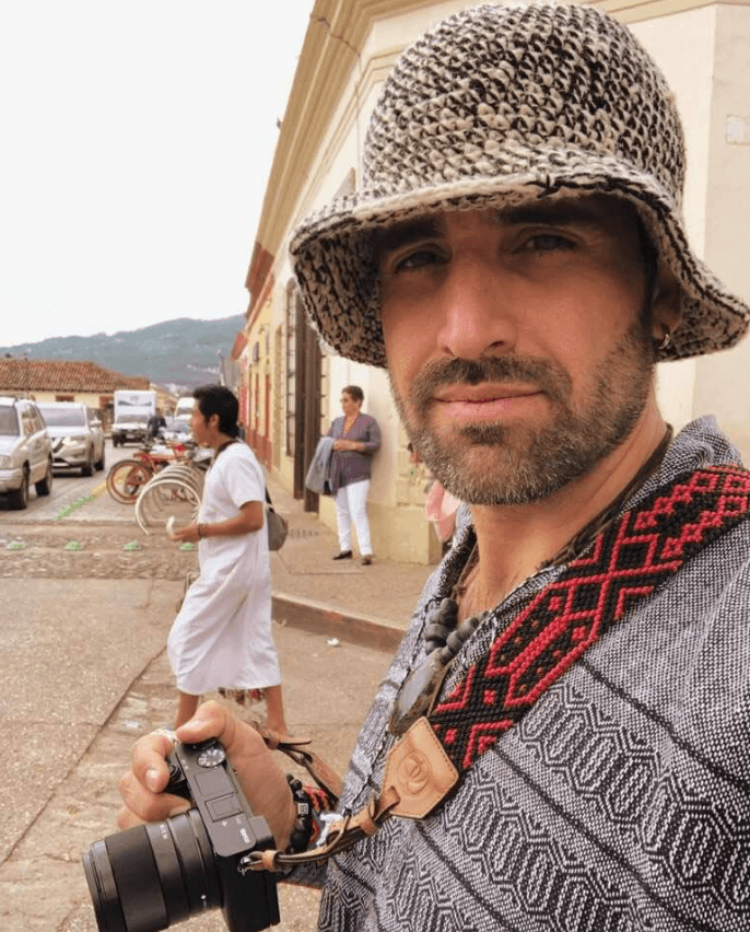 The builder traveling through a Mexican town with his camera, at home in the place he builds in.