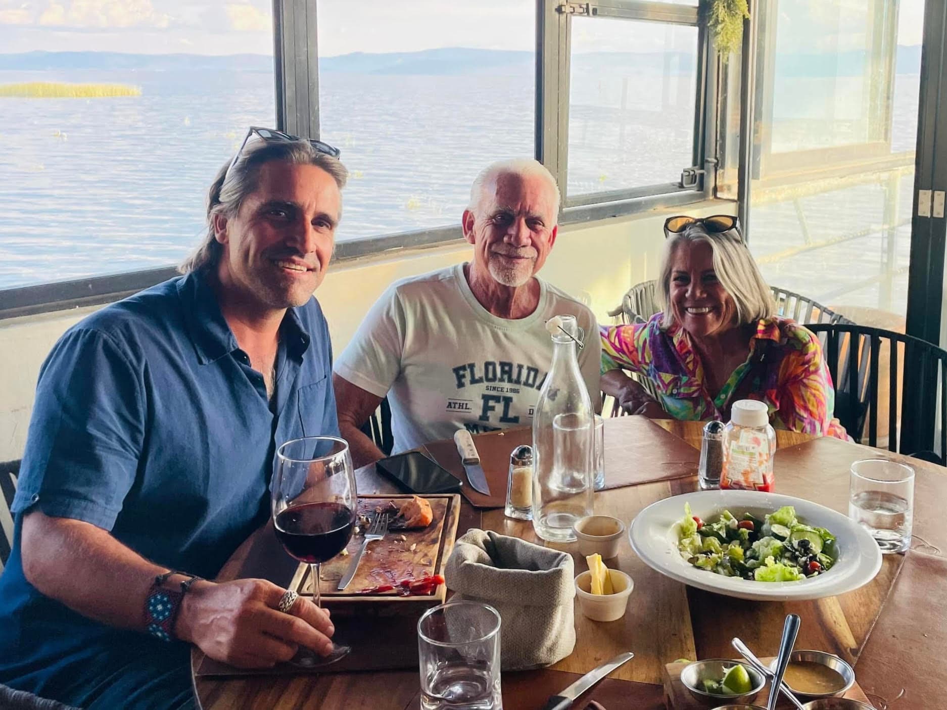 The builder, his aunt, and his father at dinner in Ajijic, the lake through the window.